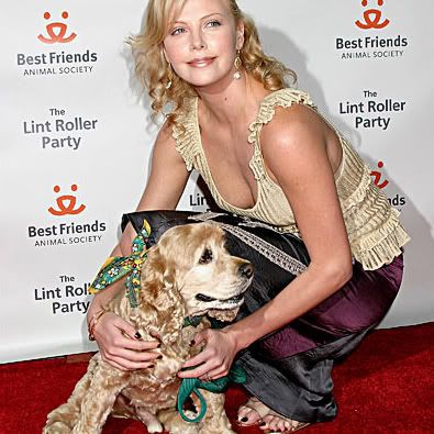 Charlize Theron, an Oscar winner, holds one of her cocker spaniels at a 
